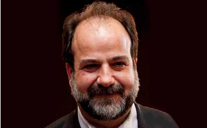 A person in formal attire on a dark background | MSC Cruises