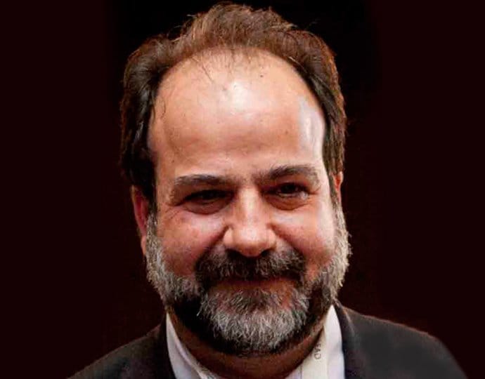 A person in formal attire against a dark background | MSC Cruises A person in formal attire against a dark background | MSC Cruises