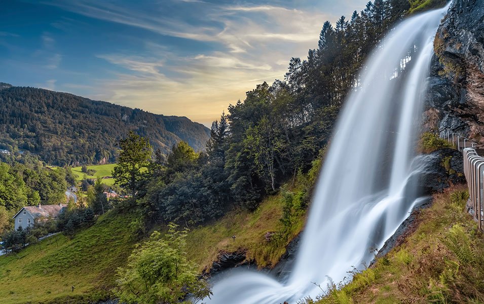 A breathtaking waterfall surrounded by lush greenery in a serene valley | MSC Cruises A breathtaking waterfall surrounded by lush greenery in a serene valley | MSC Cruises