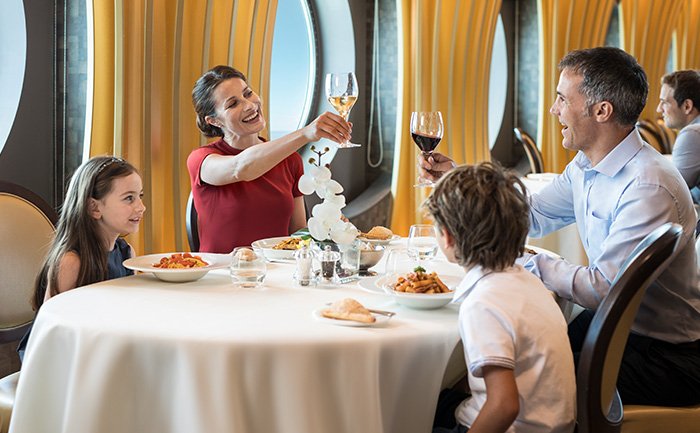 Family enjoying fine dining in an elegant restaurant with ocean views | MSC Cruises Family enjoying fine dining in an elegant restaurant with ocean views | MSC Cruises