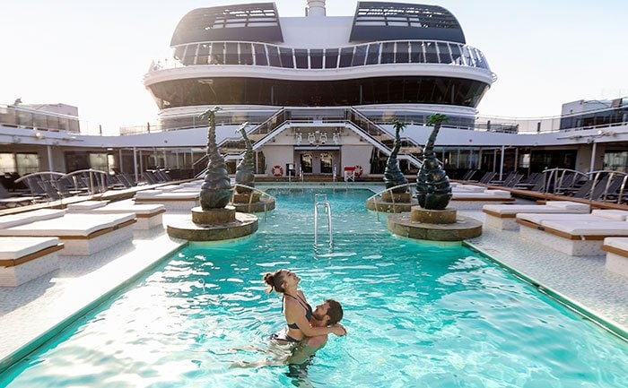 Couple enjoying a pool on an MSC cruise ship deck | MSC Cruises Couple enjoying a pool on an MSC cruise ship deck | MSC Cruises