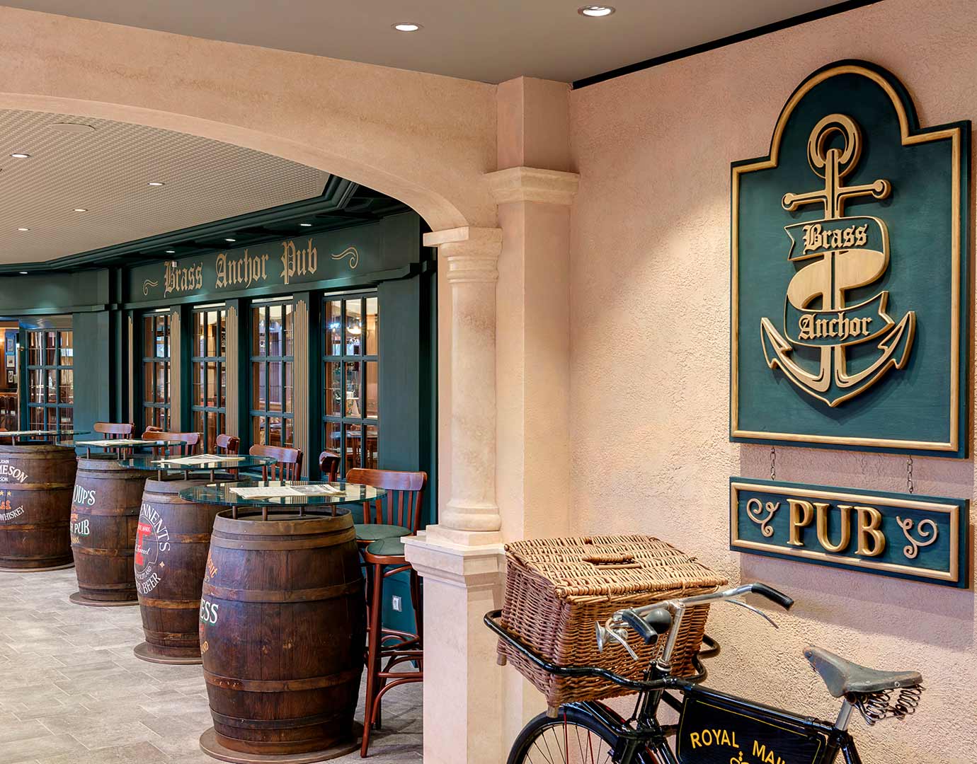 The Brass Anchor Pub with barrel tables and a vintage bicycle on an MSC cruise ship | MSC Cruises The Brass Anchor Pub with barrel tables and a vintage bicycle on an MSC cruise ship | MSC Cruises