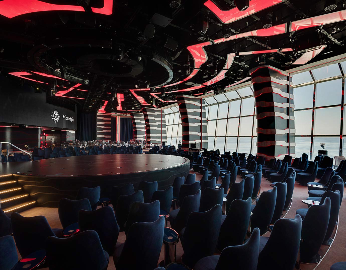 A modern theater with panoramic ocean views and vibrant lighting onboard MSC Meraviglia | MSC Cruises A modern theater with panoramic ocean views and vibrant lighting onboard MSC Meraviglia | MSC Cruises