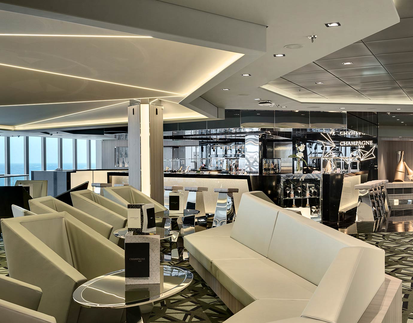 Luxurious champagne bar with modern seating and ocean views onboard | MSC Cruises Luxurious champagne bar with modern seating and ocean views onboard | MSC Cruises
