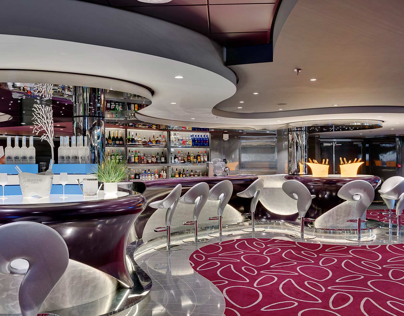 Modern cruise ship bar with sleek seating, vibrant decor, and a wide selection of drinks | MSC Cruises Modern cruise ship bar with sleek seating, vibrant decor, and a wide selection of drinks | MSC Cruises